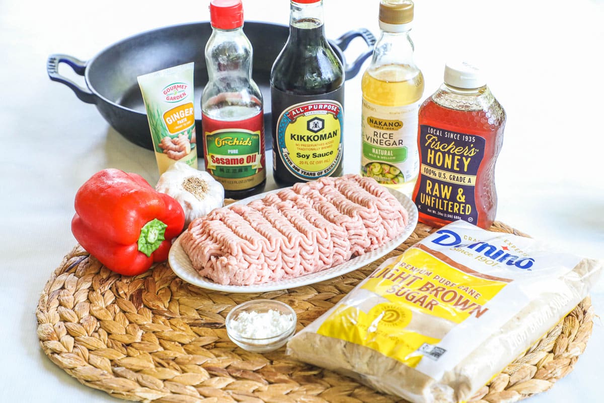 Ingredients to make teriyaki ground turkey including turkey meat, bell pepper, soy sauce, garlic, ginger, brown sugar, and honey.