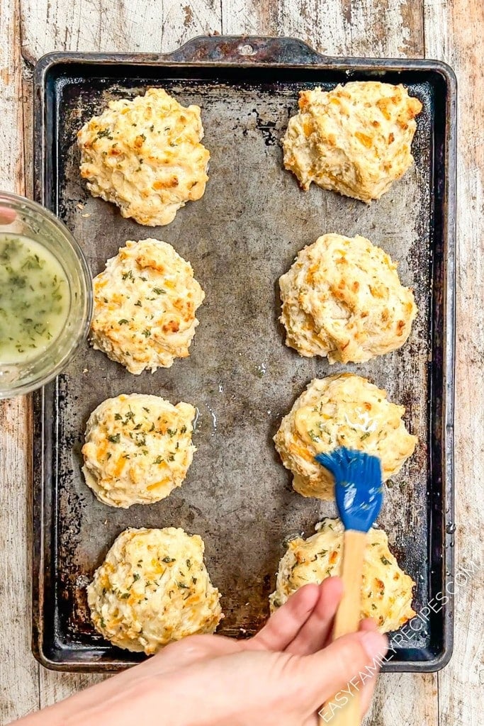above image of cheddar bay biscuits on a baking sheet.