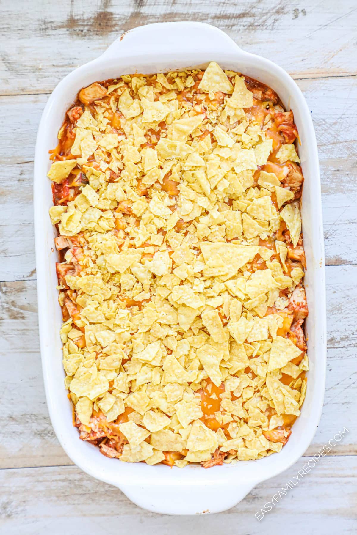 Step 3 How to make chicken taco casserole top with cheese and crushed chips and bake