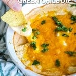 Dipping chip into hot green chile dip with cheese