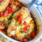 Lifting chicken out of the baking dish with a spatula.