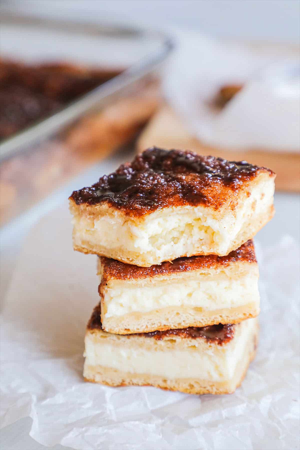 churro cheesecake squares stacked on top of each other