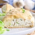 Close up of a chicken pillow cut in half so you can see the creamy, cheesy chicken filling