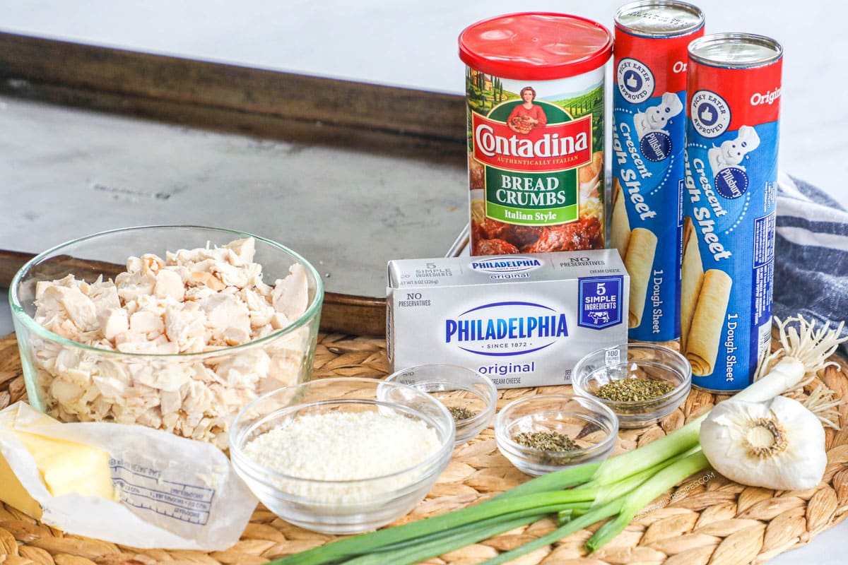 Garlic Herb Chicken Pillows recipe ingredients including pillsbury crescent rolls cream cheese, rotisserie chicken, garlic, herbs, bread crumbs, parmesan cheese, butter