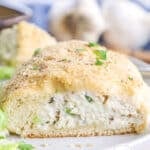 Close up of a chicken pillow cut in half so you can see the creamy, cheesy chicken filling