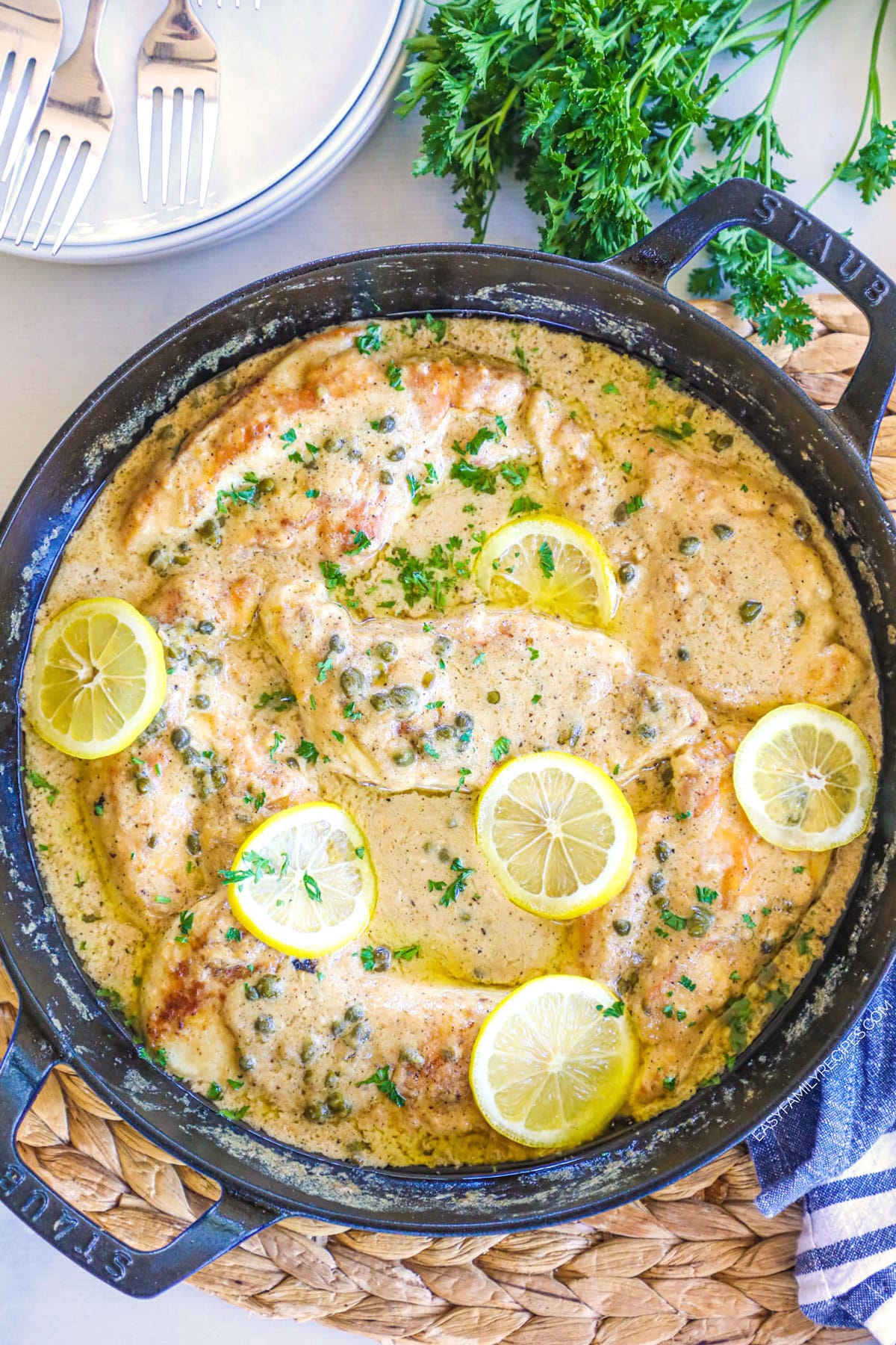 Creamy Chicken Piccata garnished with Lemon and parsley.