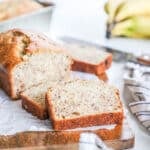 Banana bread cut into slices and arranged on a board ready to eat.