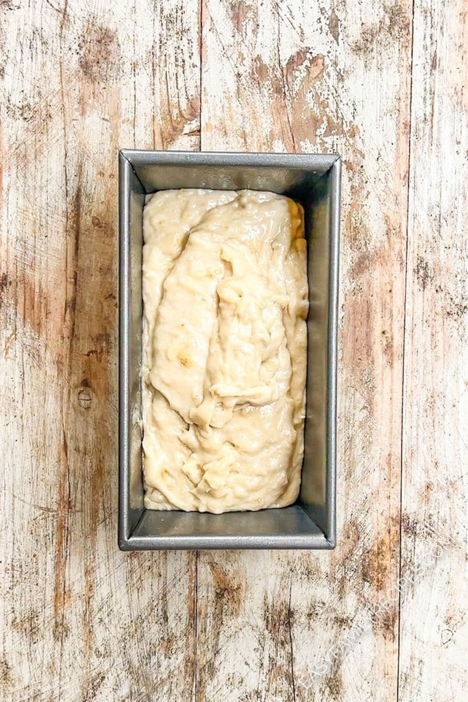 Banana bread batter in a loaf pan, ready to bake.