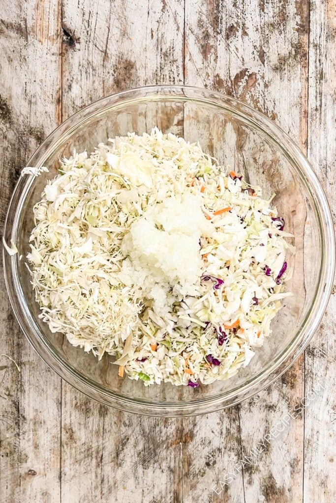 Shredded cabbage and coleslaw dressing ready to be mixed together for classic Southern coleslaw.
