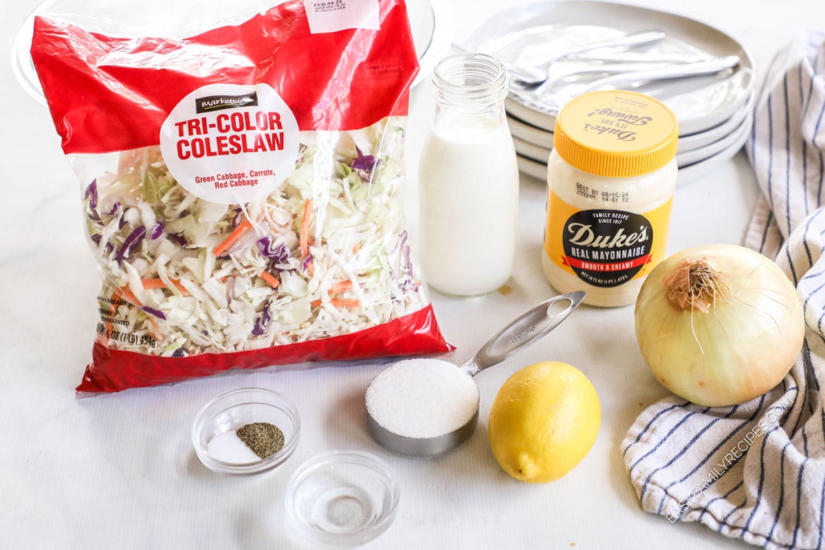 Ingredients for classic Southern coleslaw including shredded cabbage, mayo, and lemon.