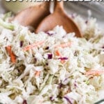 A close-up of classic Southern coleslaw salad in a glass bowl with two wooden spoons. The text "Southern Coleslaw."