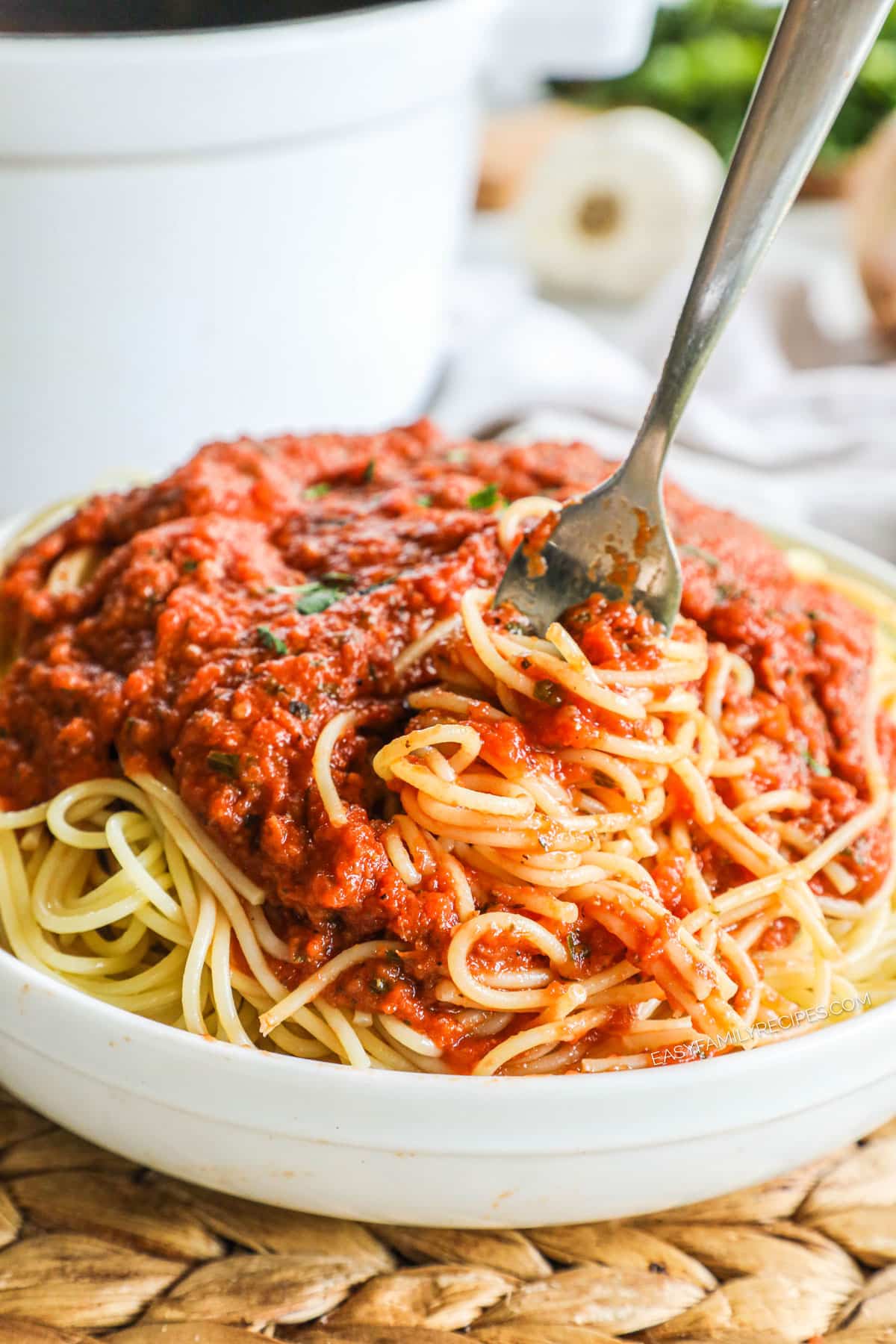 Swirling a fork in a big bowl of homemade spaghetti marinara.