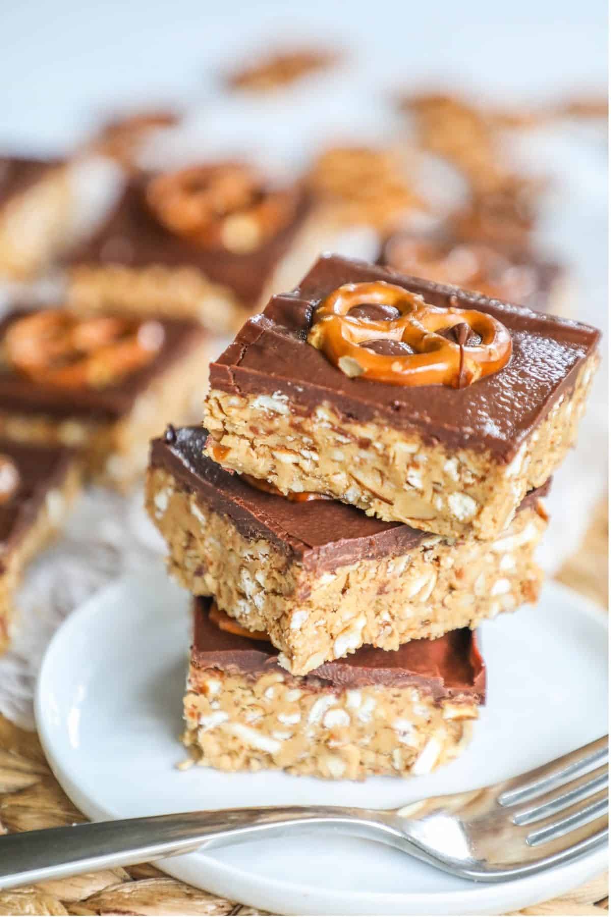 chocolate peanut butter pretzel bars stacked on a plate