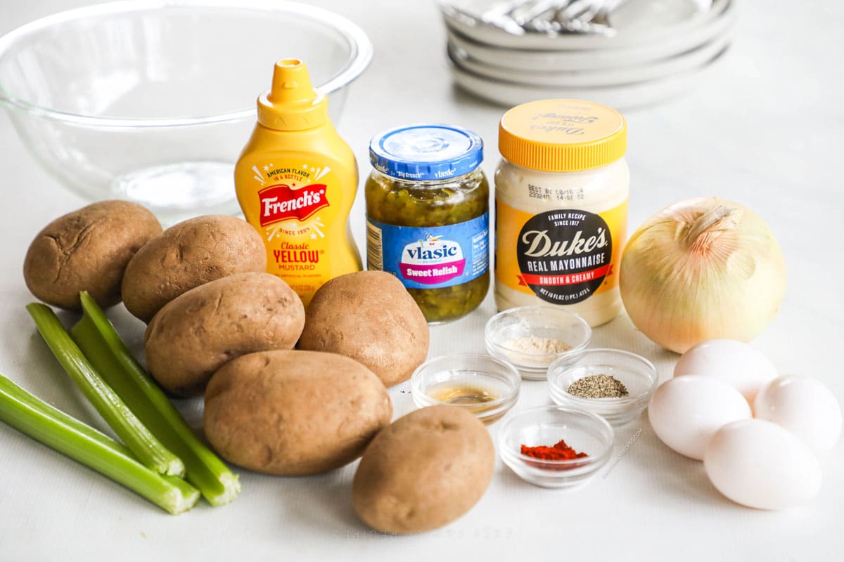 Ingredients for recipe before prepping: celery, potatoes, onion, spices, mustard, sweet relish, garlic, and mayo.