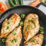 Four Baja Chicken breasts on a saute pan with herb and jalapeño garnish. The text reads "Baja Chicken."