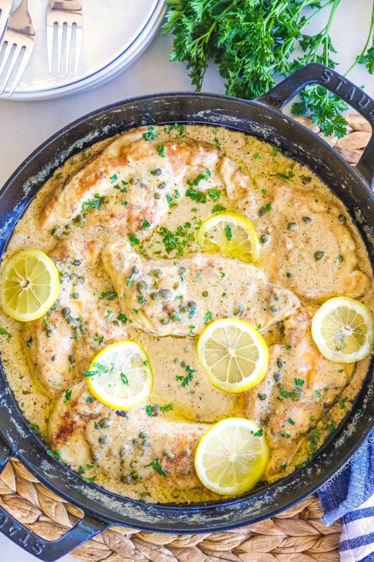 chicken piccata with lemon and cappers in a skillet