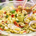 Cilantro lime pasta salad with farfalle pasta in a large glass bowl.