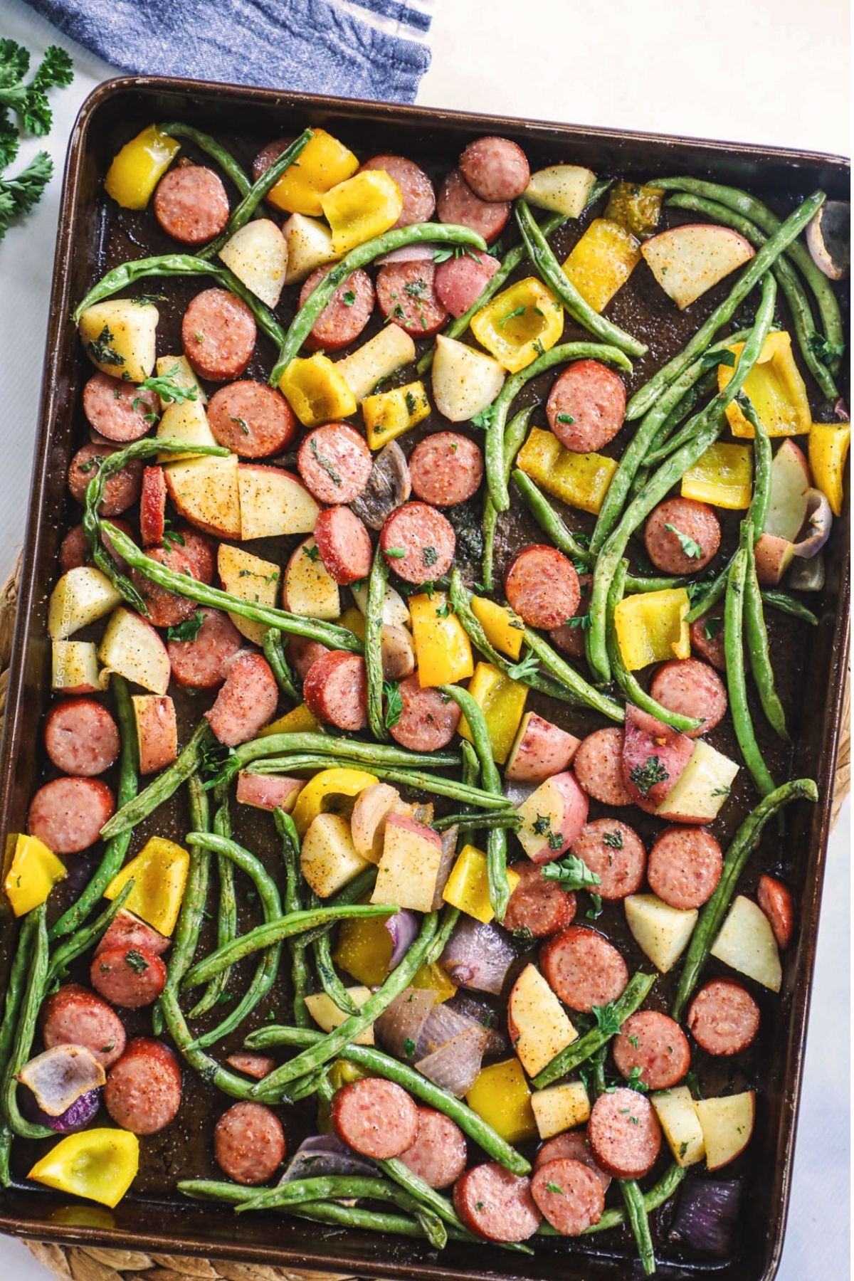sausage and veggies cooked on a sheet pan
