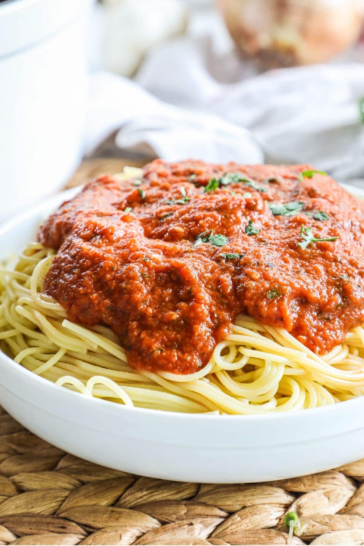 spaghetti with marinara in a white bowl
