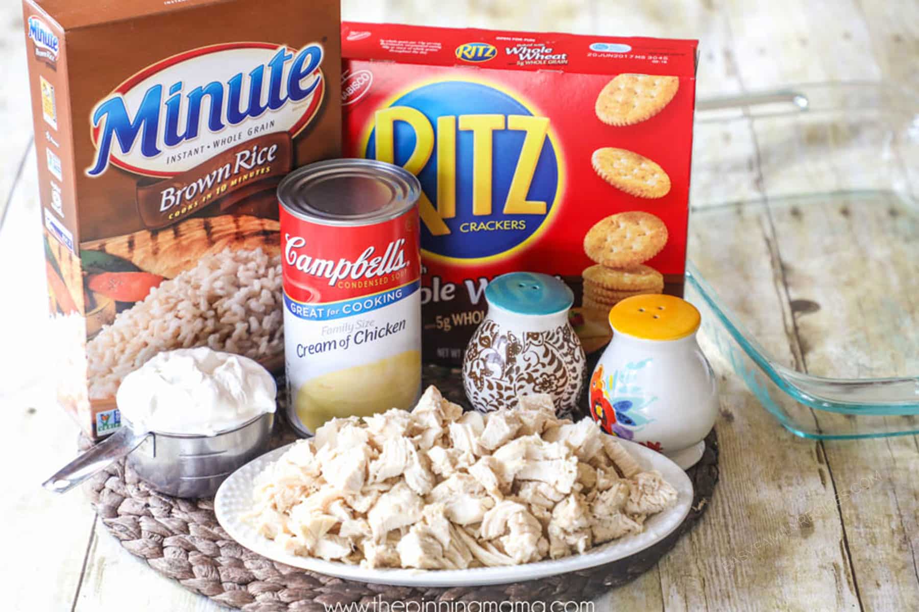 Ingredients for making creamy chicken rice casserole including shredded chicken, campbells cream of chicken soup, sour cream, chicken broth, minute rice, and ritz crackers.