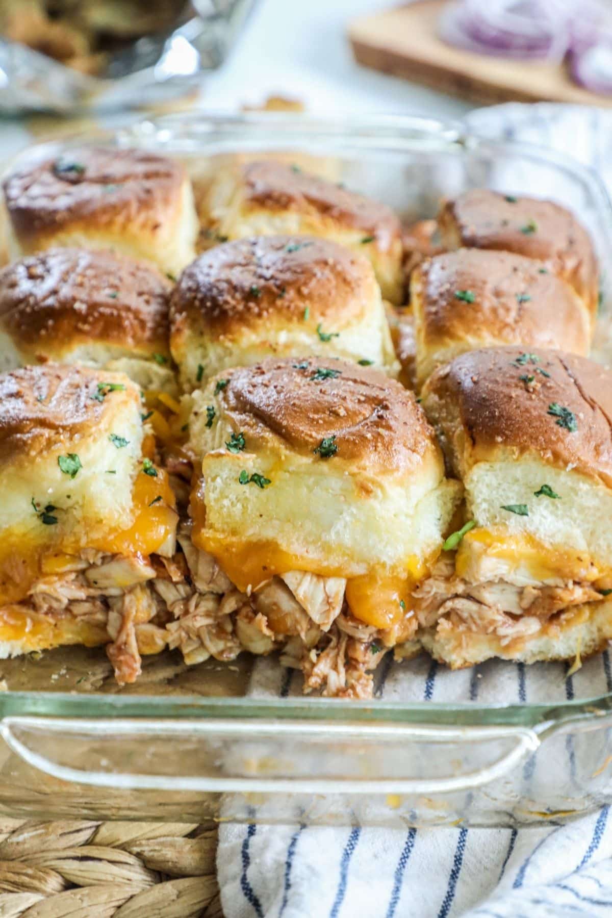 baking dish of bbq chicken sliders with cheese