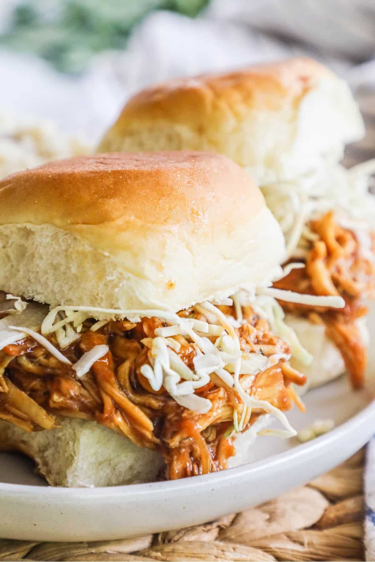 2 bbq chicken sliders with ranch slaw on a plate