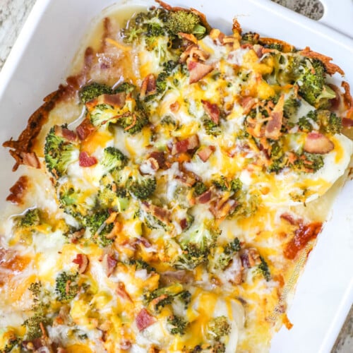 cheesy bacon ranch chicken with broccoli in a white baking dish