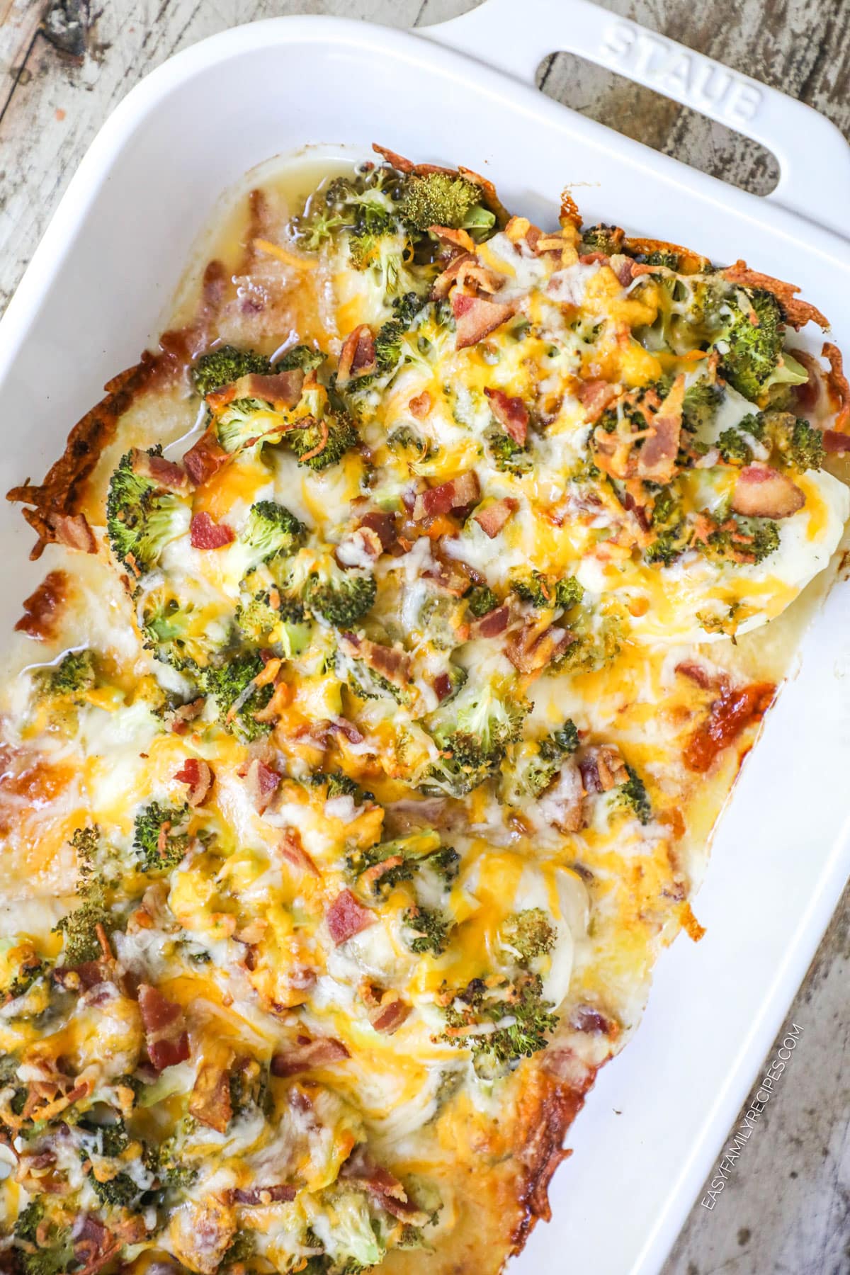 cheesy bacon ranch chicken with broccoli in a white baking dish