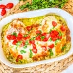 Cheesy Baked Pesto Chicken in a baking dish ready to eat for an easy dinner.