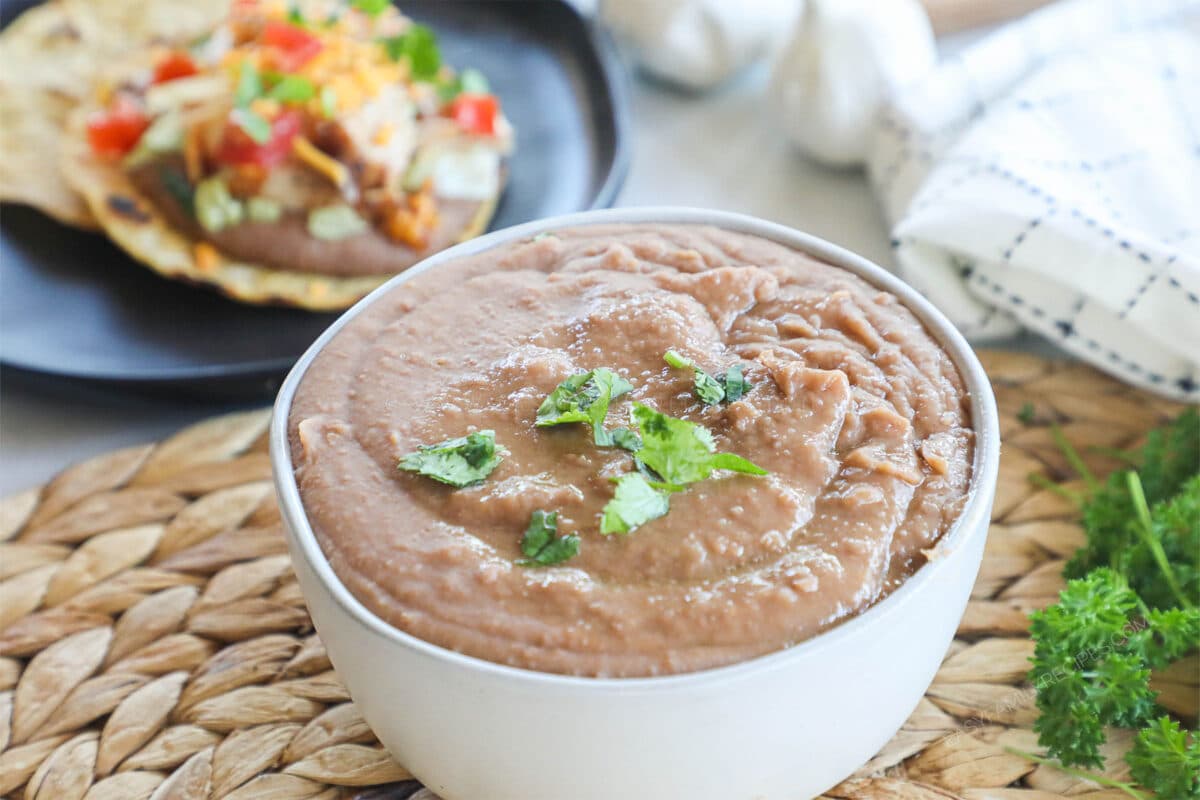 Close up of homemade refried beans in a bowl.
