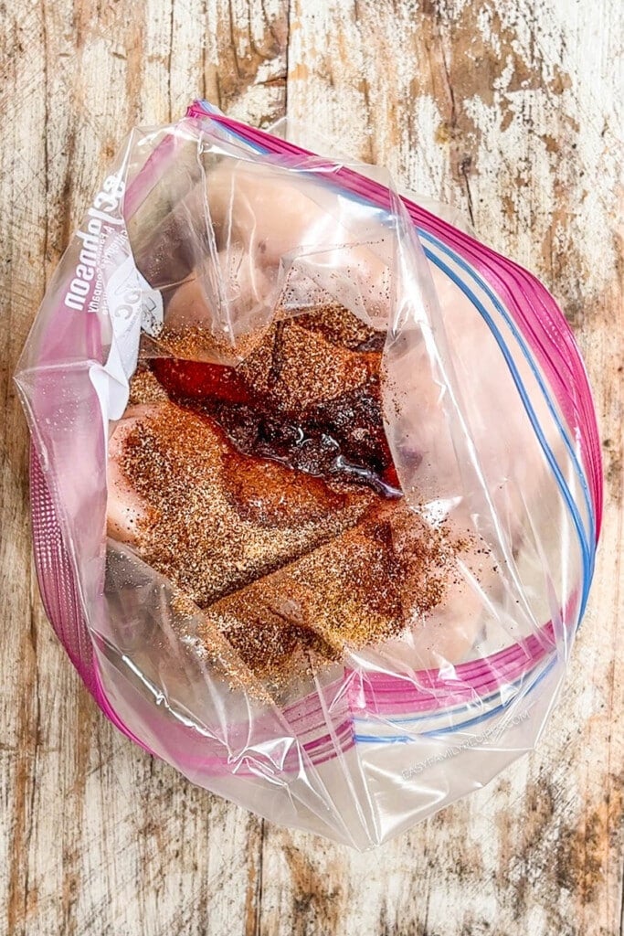 chicken in a ziplock bag covered with spices.