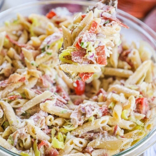 A top view of grinder pasta salad in a clear glass bowl.