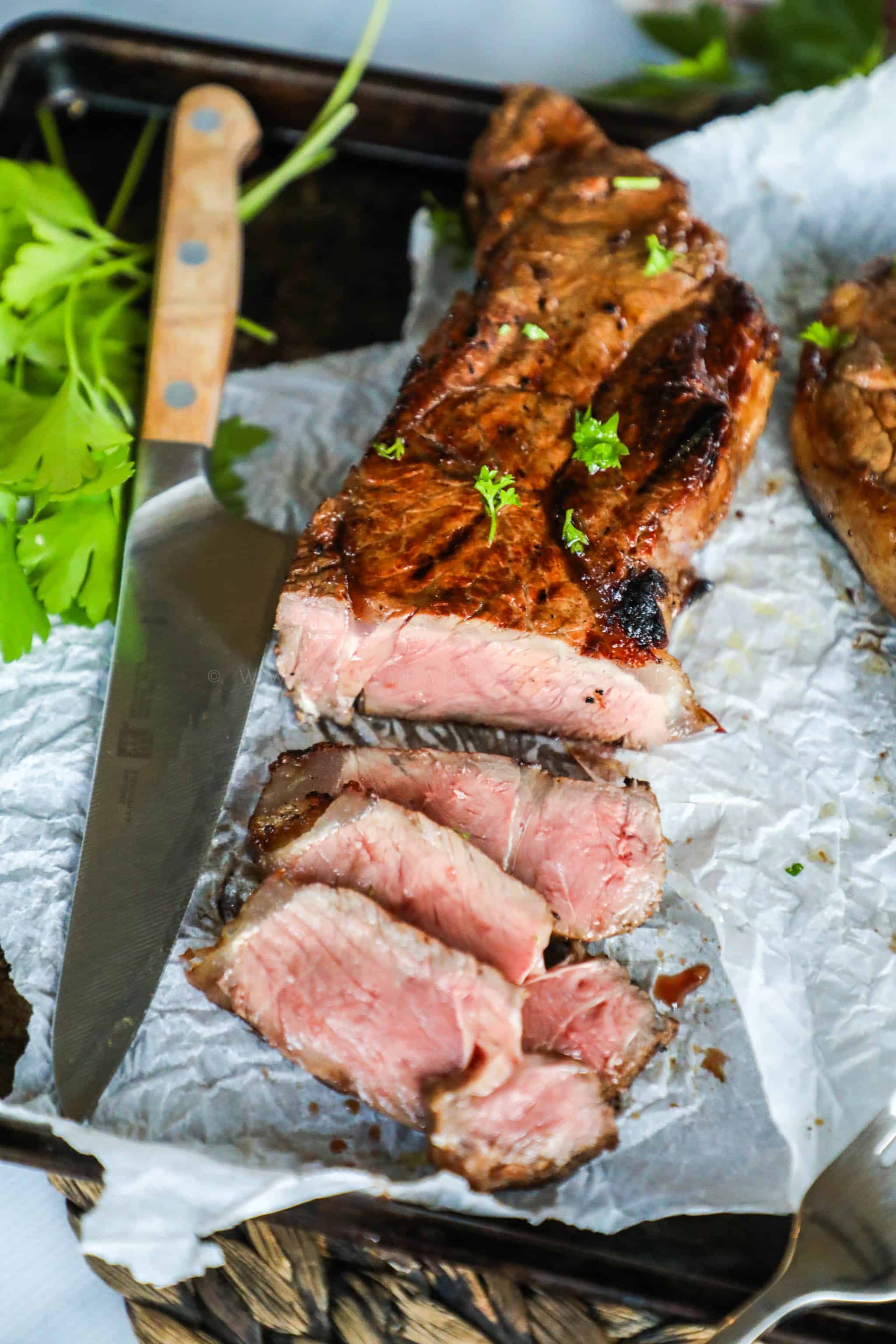 Marinated Steak sliced on a cutting board