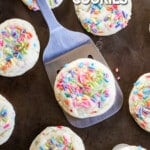 a funfetti cookie being lifted off of a tray with a spatula.