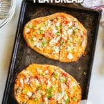 Two buffalo chicken flatbreads on a baking sheet with a white background. The text reads, "buffalo chicken flatbread."