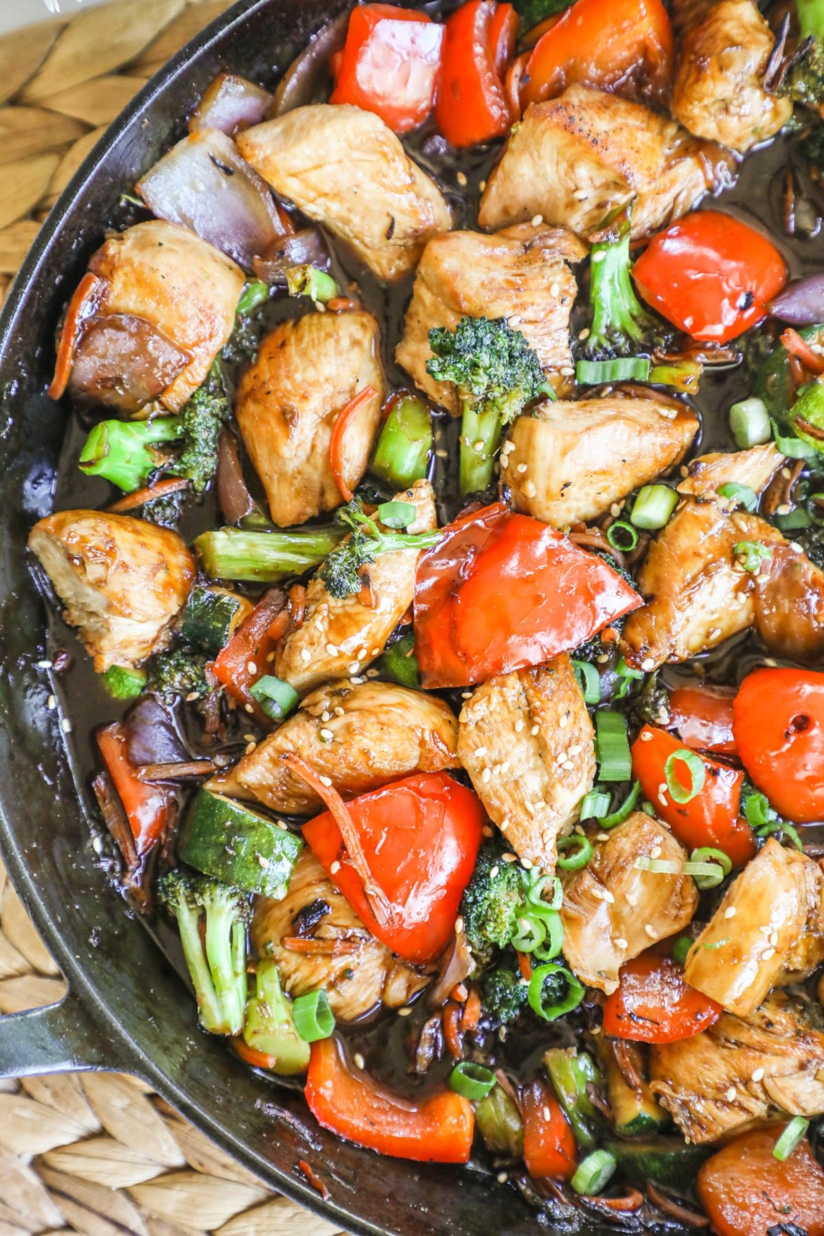 chicken peppers and broccoli stir fry in a skillet