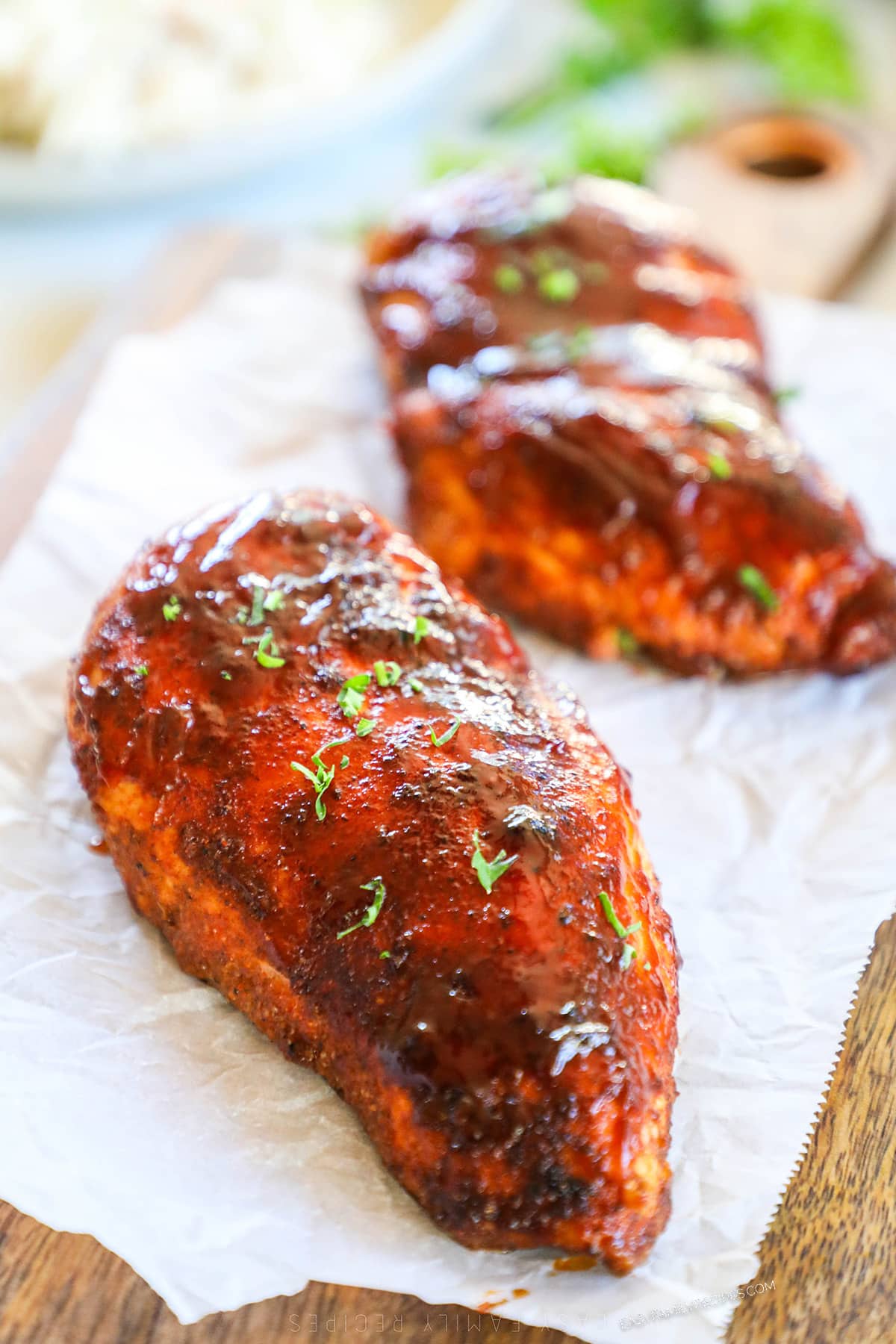 side view of baked BBQ chicken breasts.