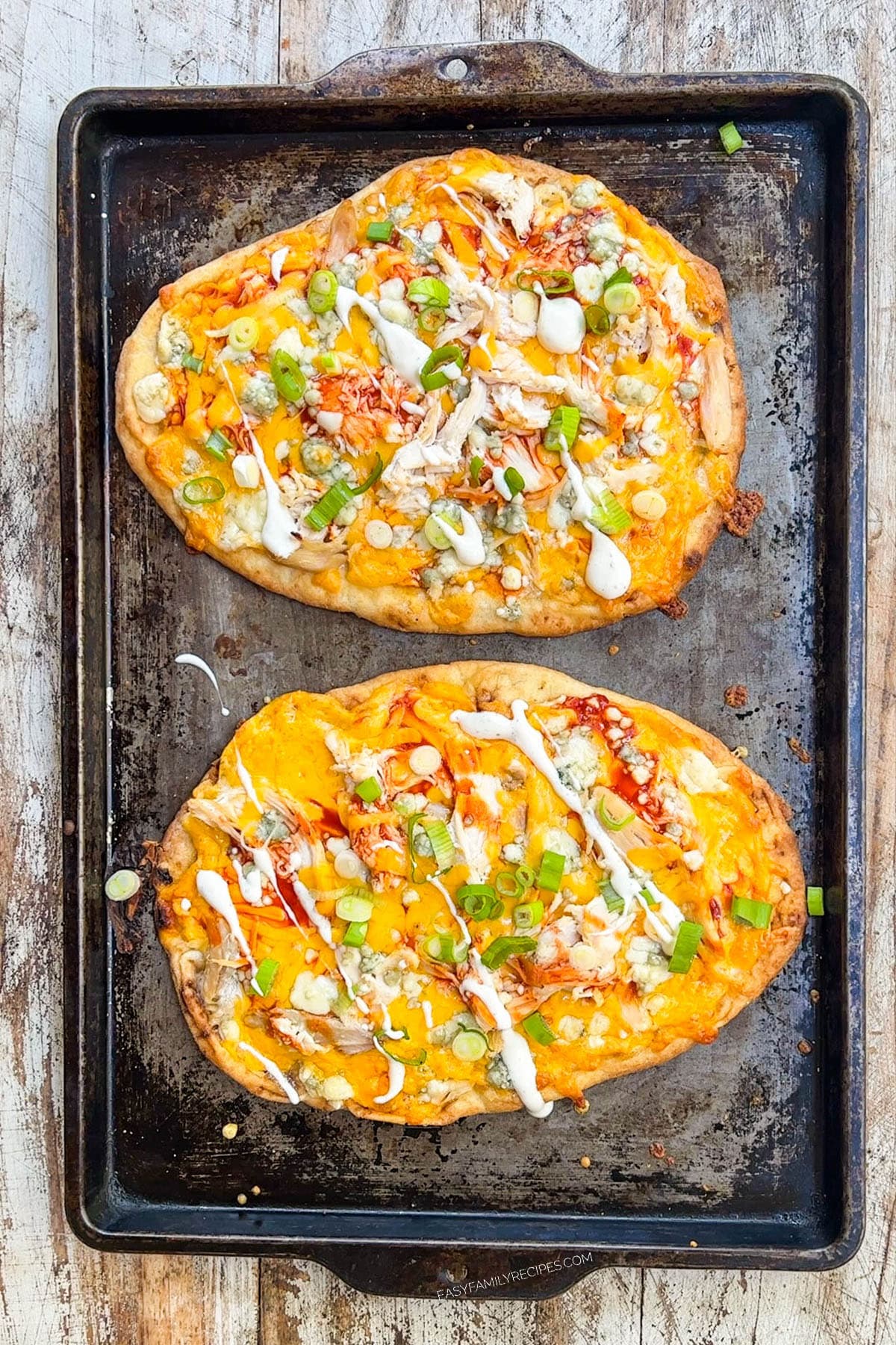 buffalo chicken flatbread on a baking sheet