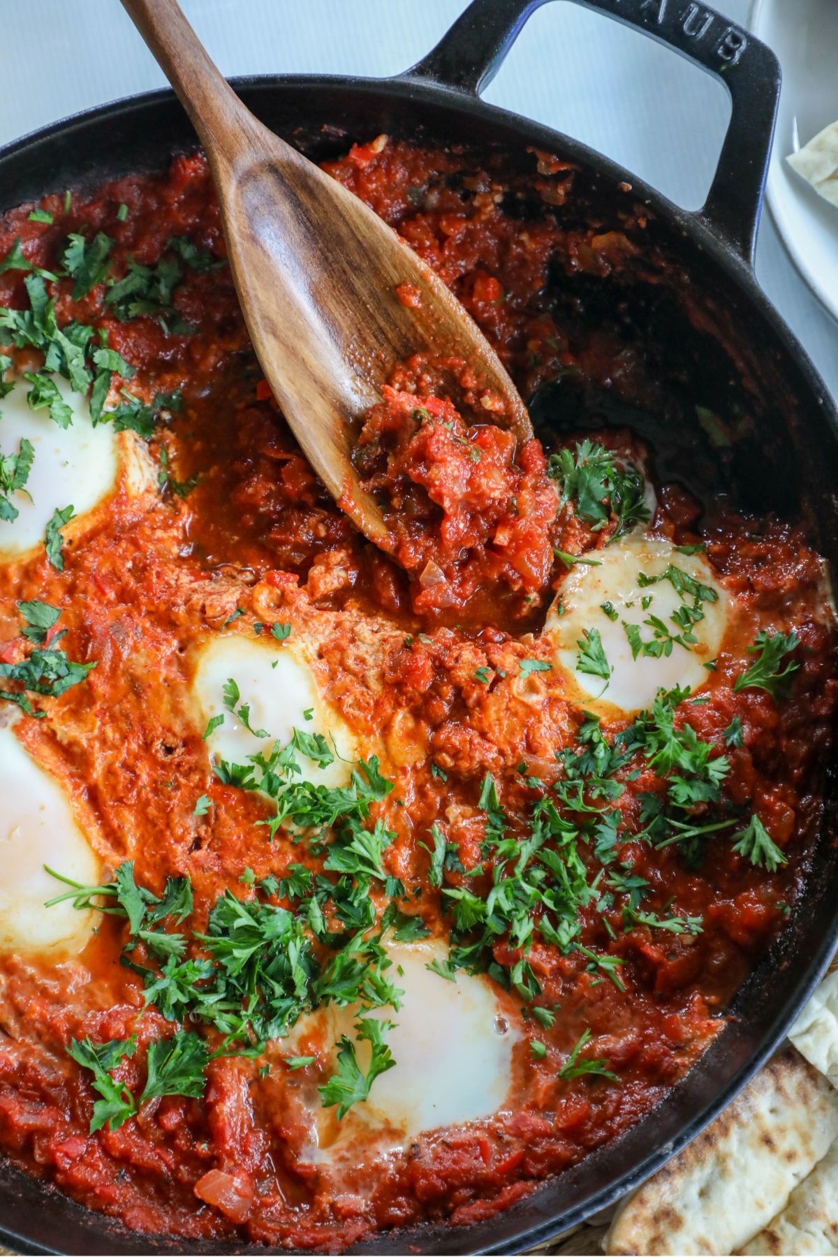shakshuka topped with parsley in a skillet