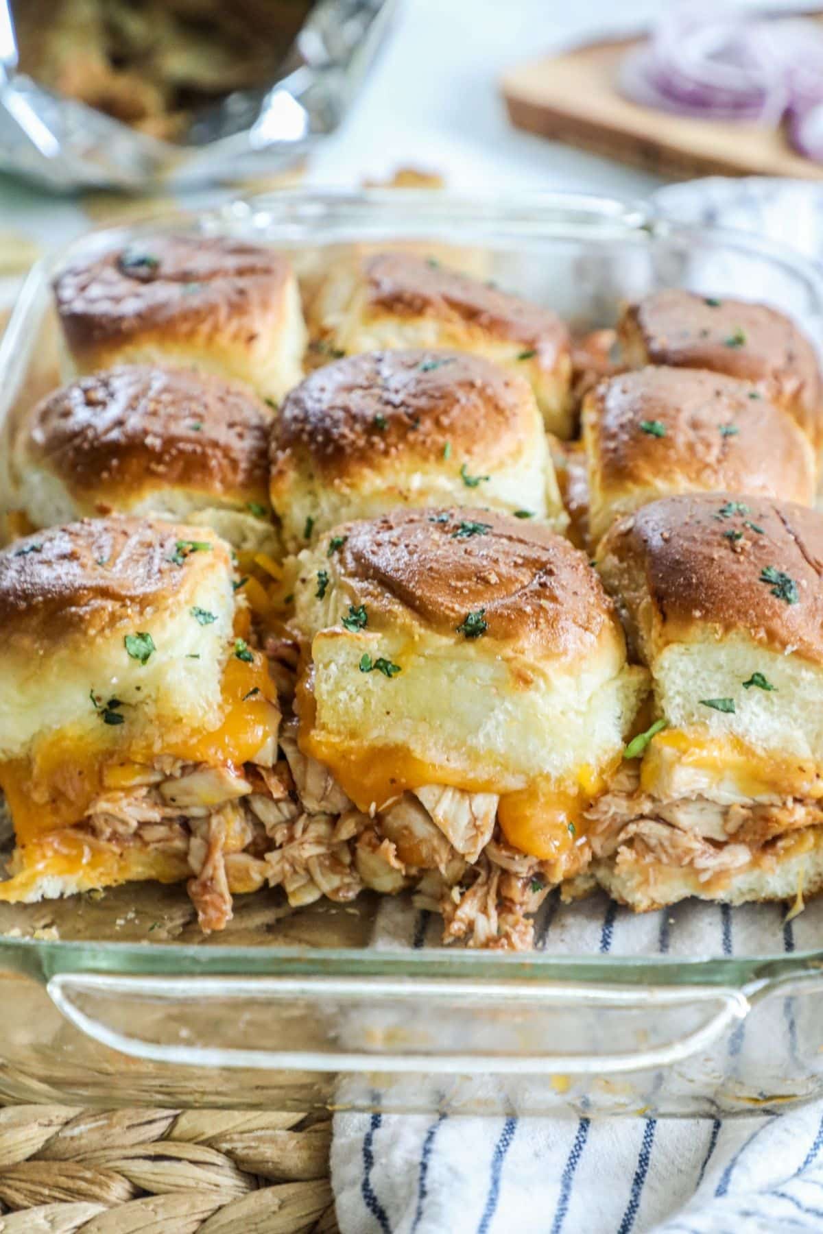 bbq pork sliders with cheese in a glass baking sheet