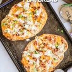 Two chicken bacon ranch flatbread pizzas on a baking sheet. The text reads, "Chicken Bacon Ranch Flatbread."