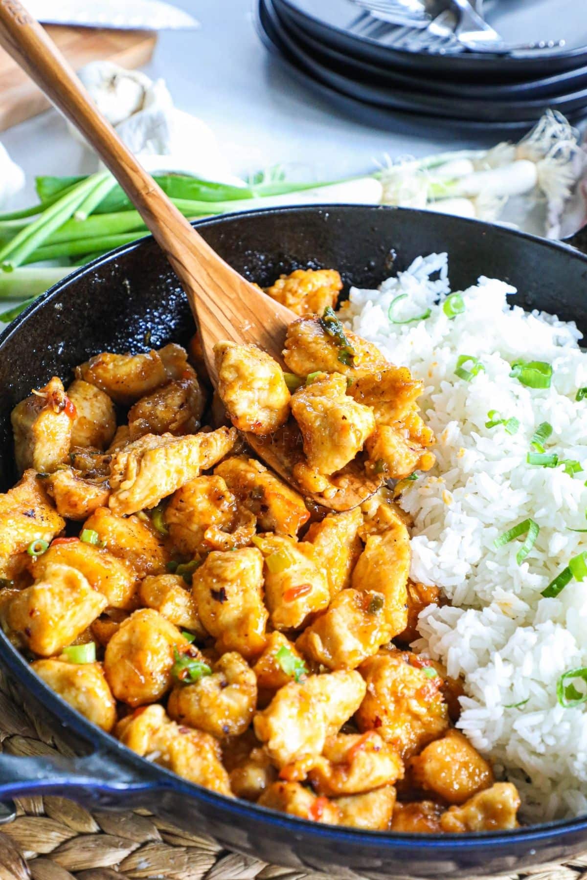 firecracker chicken bites in a skillet with white rice