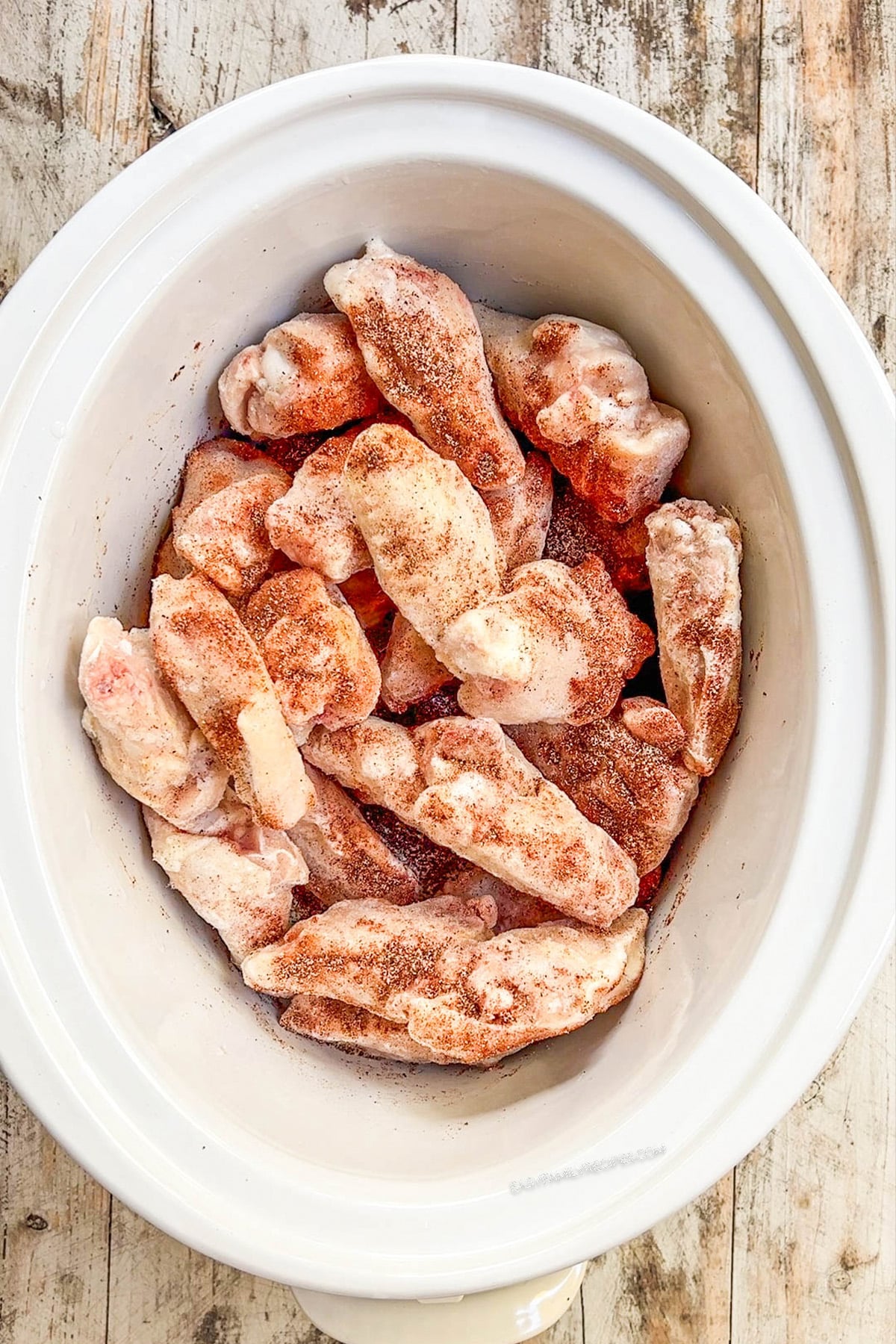 Chicken wings in a slow cooker, ready to cook.