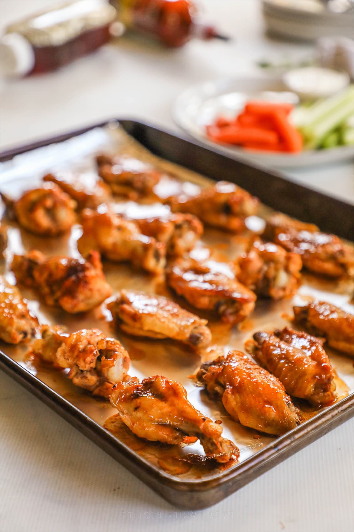 A baking sheet is lined with Asian Zing Wings that have been baked until crispy.