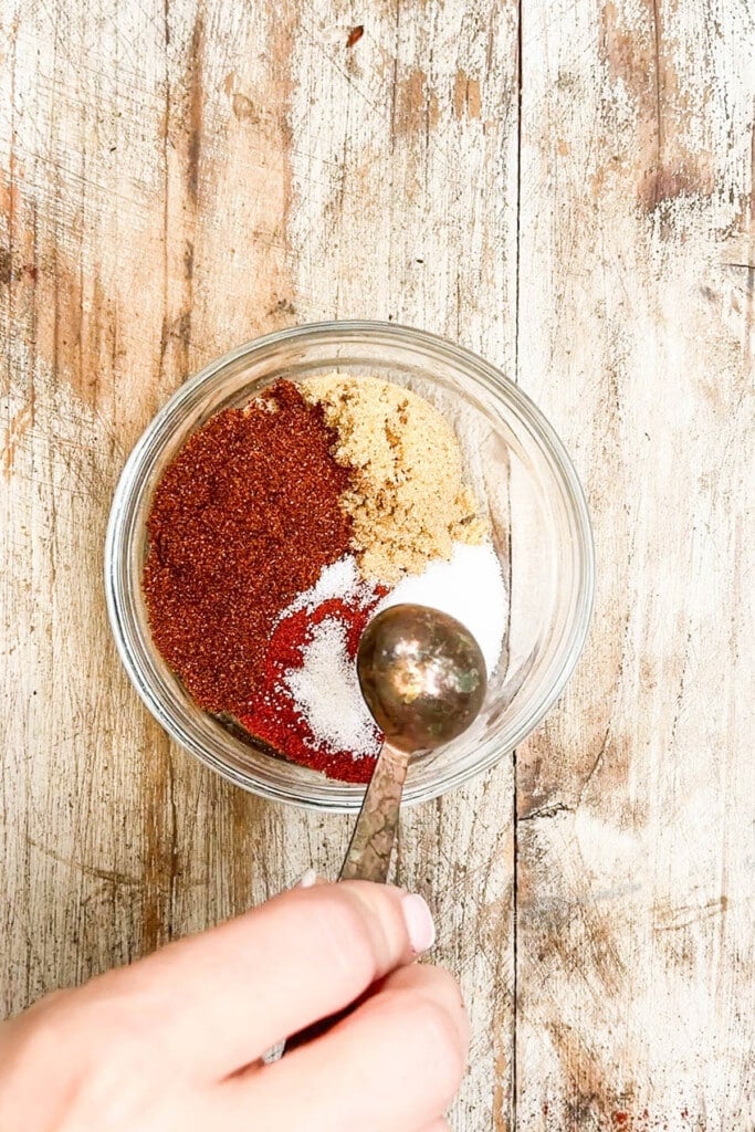 Measuring BBQ Chicken rub ingredients together.