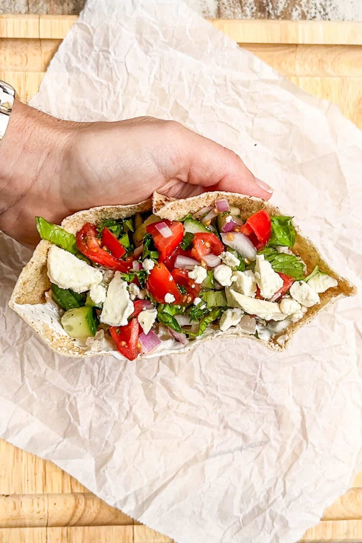 Fresh chopped veggies stuffed inside a pita with meat.