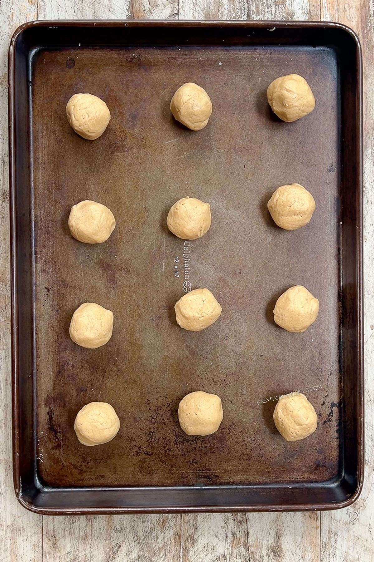 Round Peanut Butter & Jelly Cookie balls on a cookie sheet.