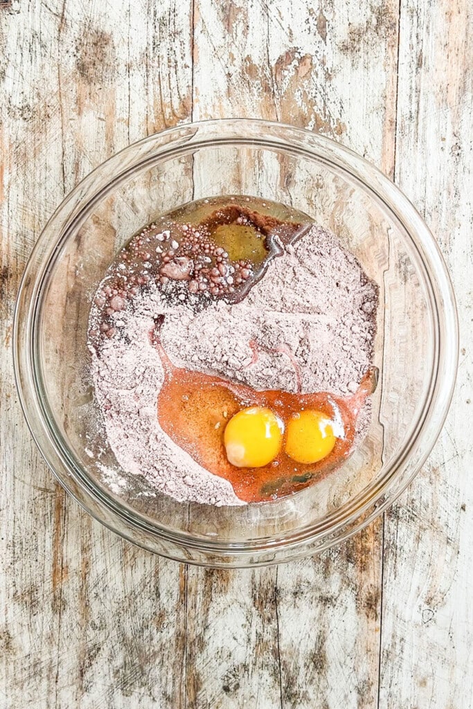 cake mix, eggs, and oil ummixed in a bowl.