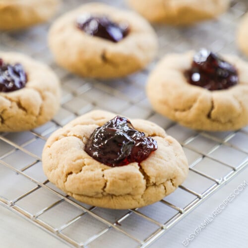 Peanut Butter & Jelly Cookies lined up on a wire rack.