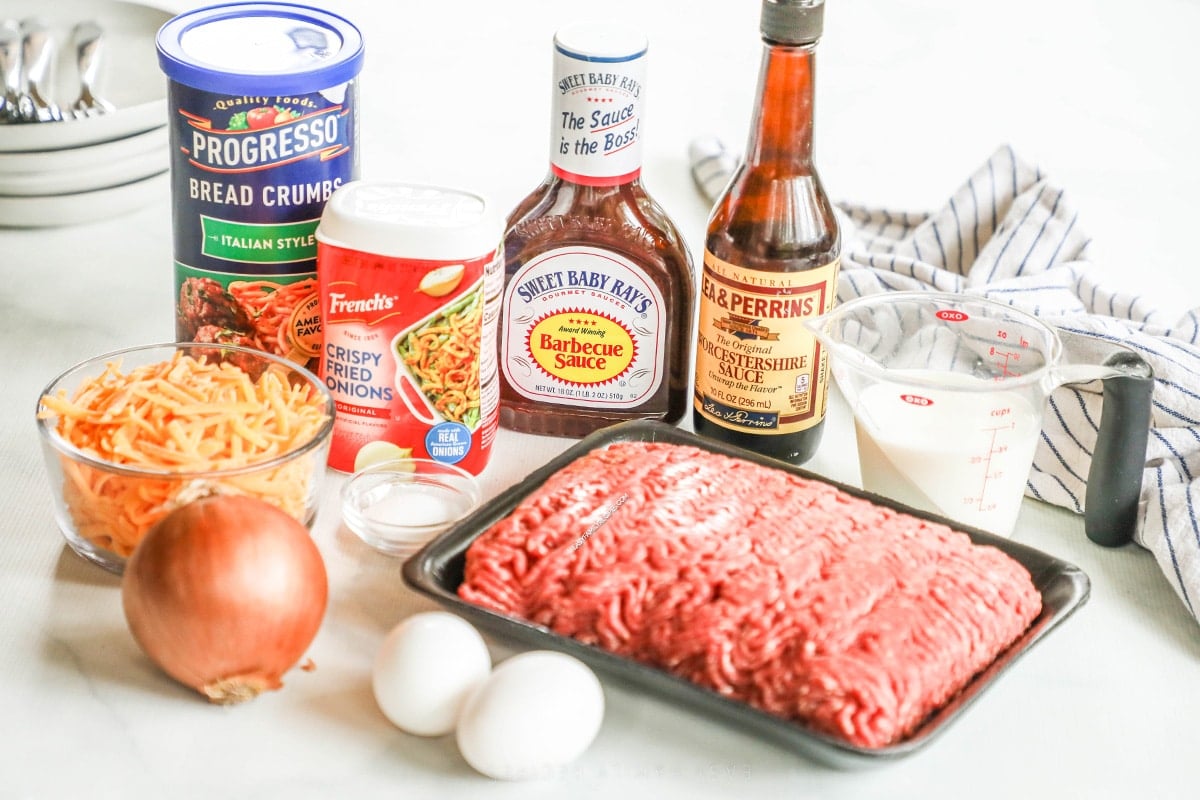 Ingredients for recipe: beef, eggs, onion, cheese, bbq sauce, Worcestershire sauce, milk, french fried onions, and breadcrumbs.